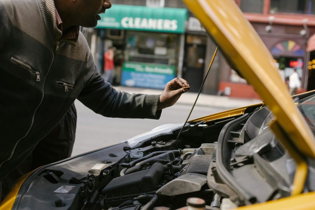 Ethnic mechanic changing detail in car engineTowing and roadside service in Fort lauderdale florida